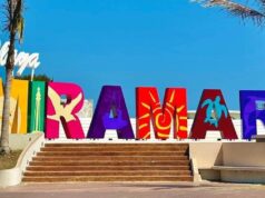 ¿Qué debes saber antes de viajar a la Playa Miramar? Letrero de la Playa Miramar con palmeras